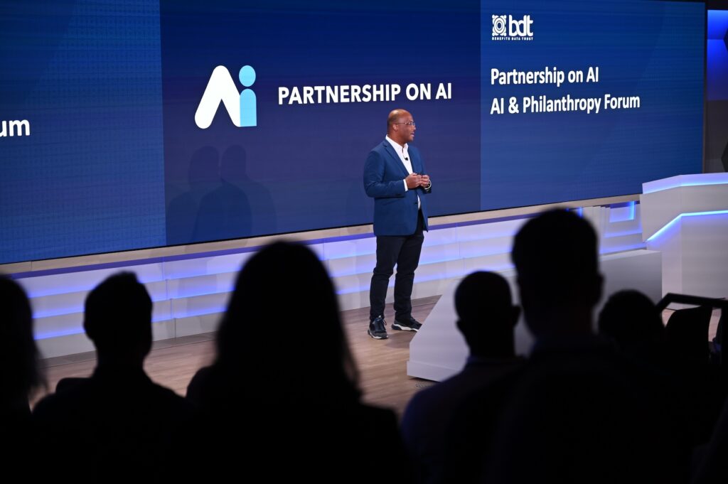 Trooper Sanders on stage presenting a talk at the AI & Philanthropy Forum in NYC